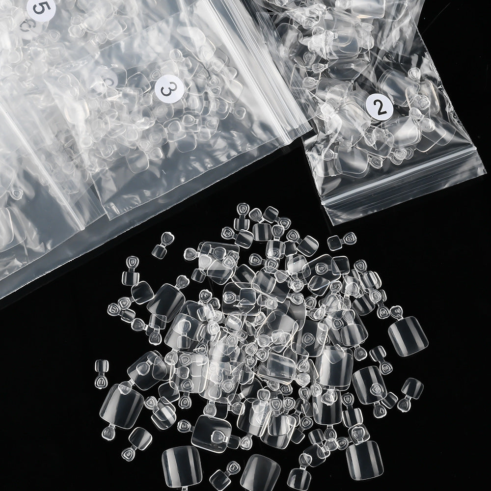 Transparent gel toenail tips (600ct) for flawless professional pedicures & durable DIY nail enhancements.