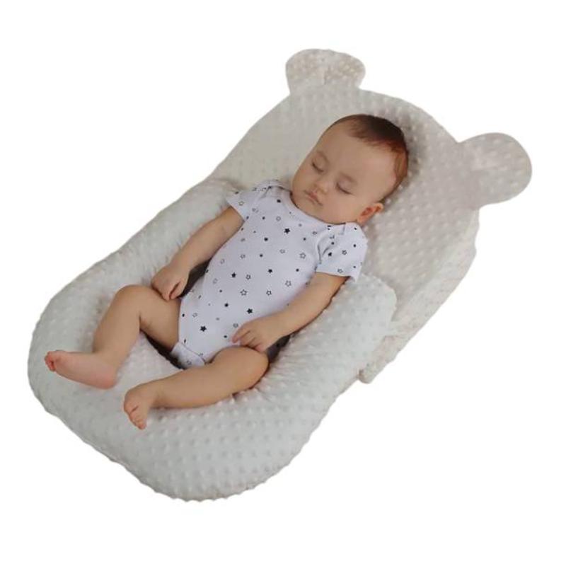 Portable baby feeding pillow, adjustable for optimal anti-reflux & anti-spit-up support during infant feeding.
