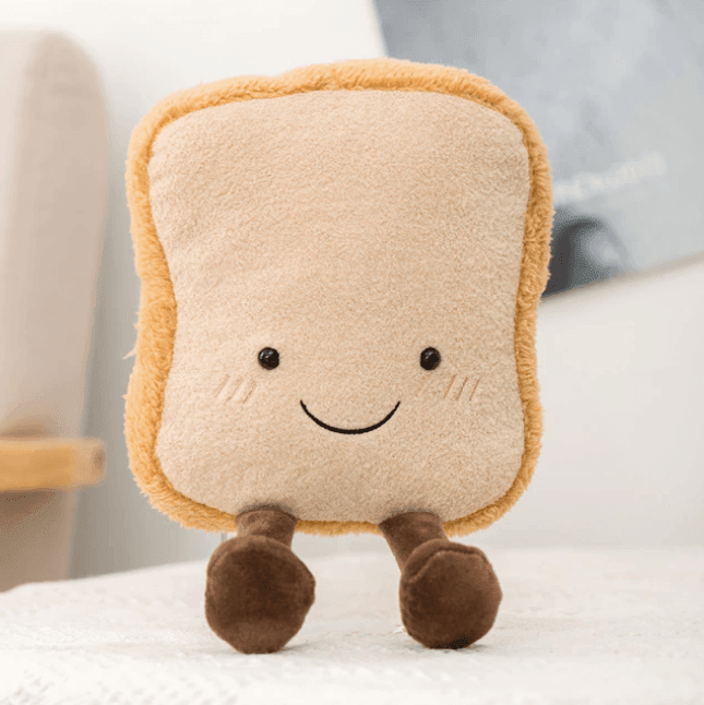 Fluffy croissant plush toy. Unisex soft stuffed pastry animal, a charming comfort toy and cute decor for any room.