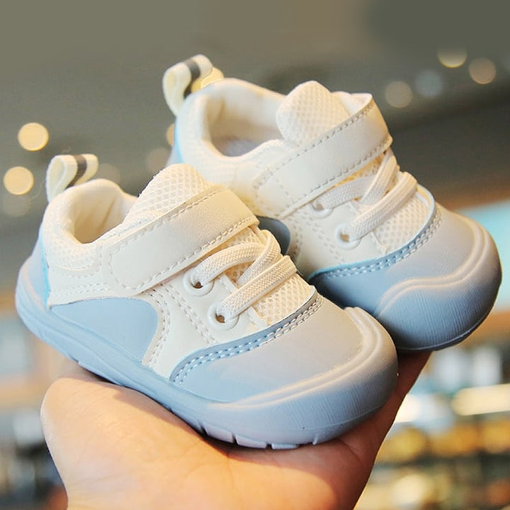 Anti-slip baby shoes with wide toe box, promoting healthy foot growth. Comfortable support for early walkers.
