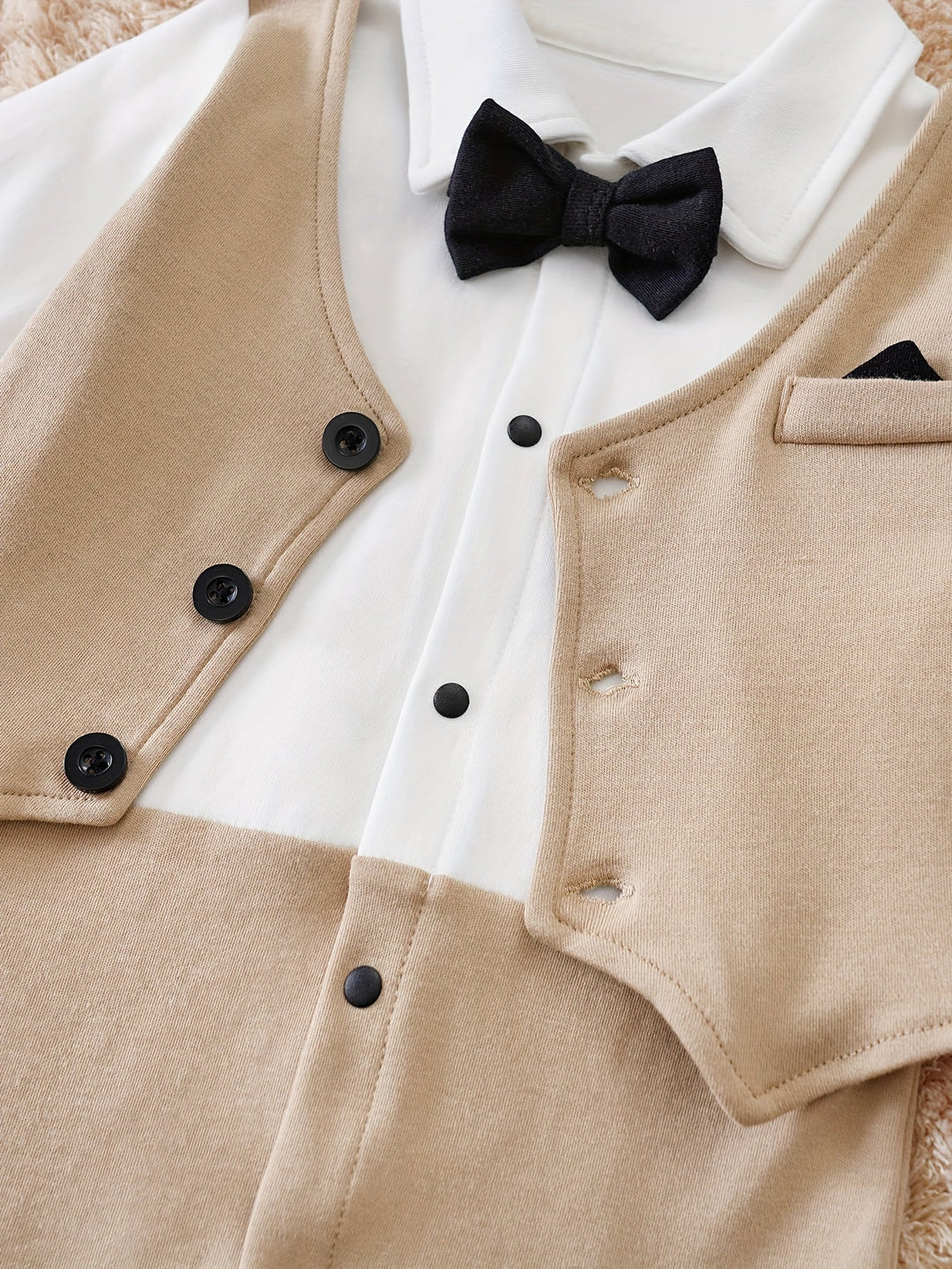 Chic infant gentleman outfit: a baby boy romper in soft cotton, complete with a charming bow tie.