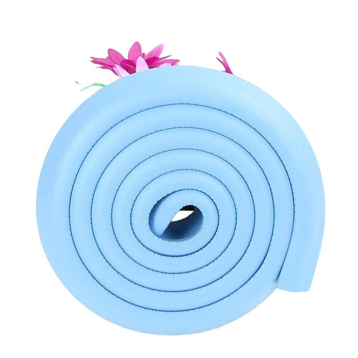 White soft foam edge protector safeguards toddlers from sharp furniture. Child proofing bumper for home safety.