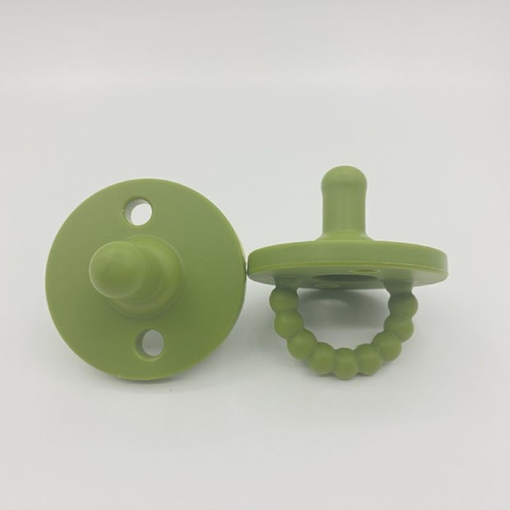 Soft, medical-grade silicone teether & pacifier provides safe developmental support & comfort.