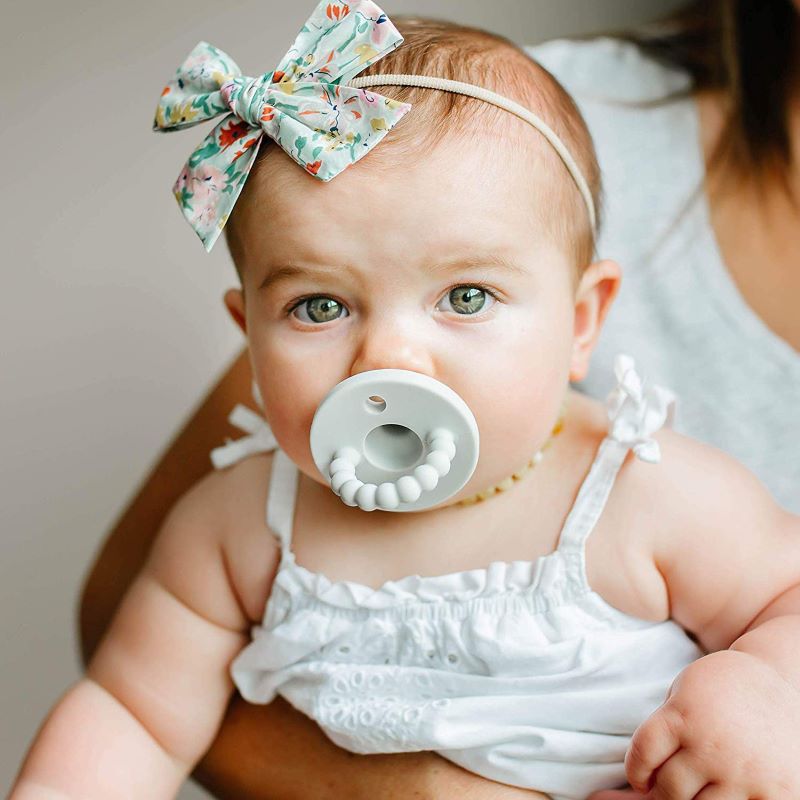 Soft silicone baby pacifier, ideal for newborn comfort & developmental support. BPA-free material.