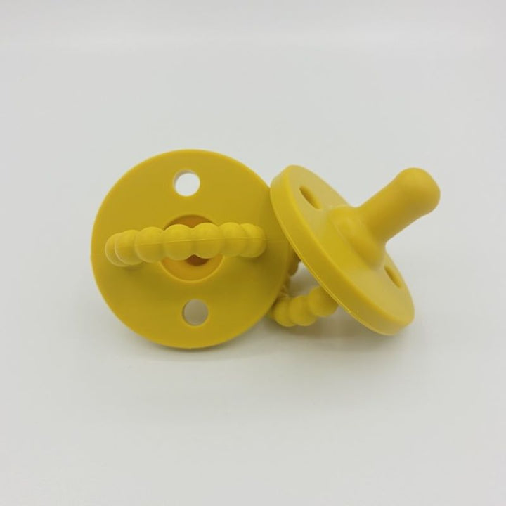 Premium silicone pacifier & teether combo, ensuring baby comfort & developmental support. Safe & BPA-free.