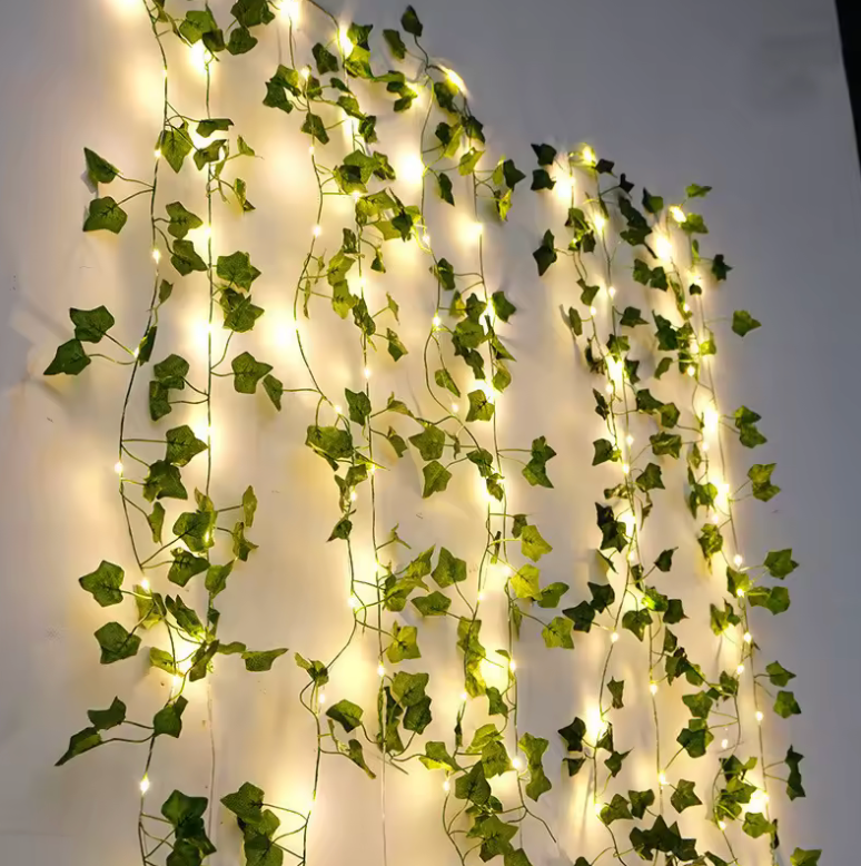 Battery-powered vine fairy lights: green leaf garland with warm LED glow, perfect for home & wedding decor.