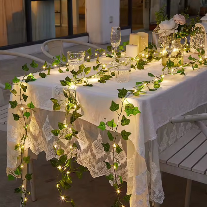 Flexible green leaf vine fairy lights with warm LEDs, battery-powered for versatile indoor ambiance lighting.