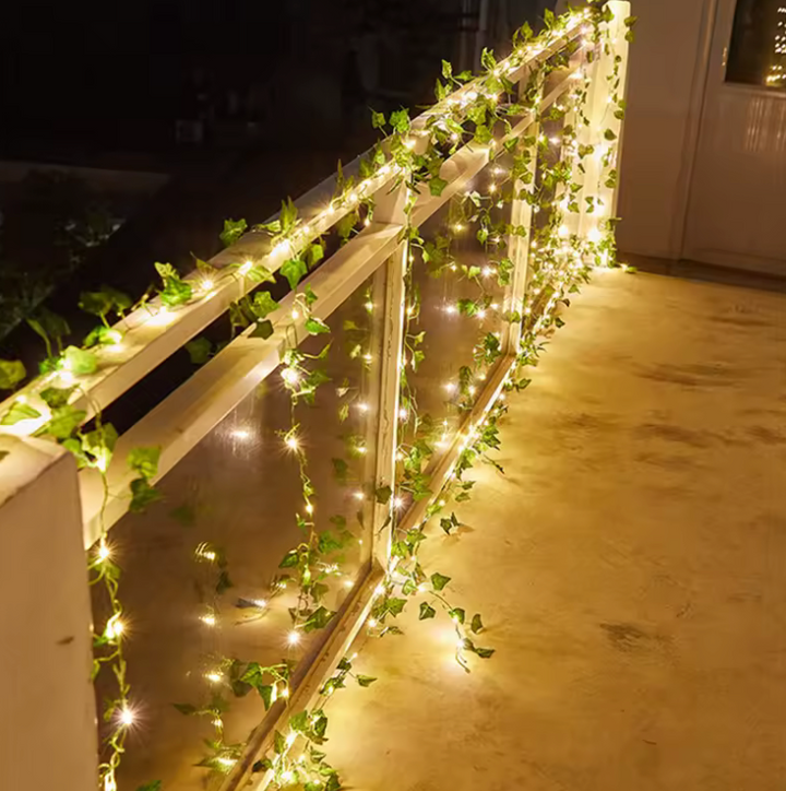 Decorative green leaf garland fairy lights, battery-powered for easy placement & a warm, natural ambiance.