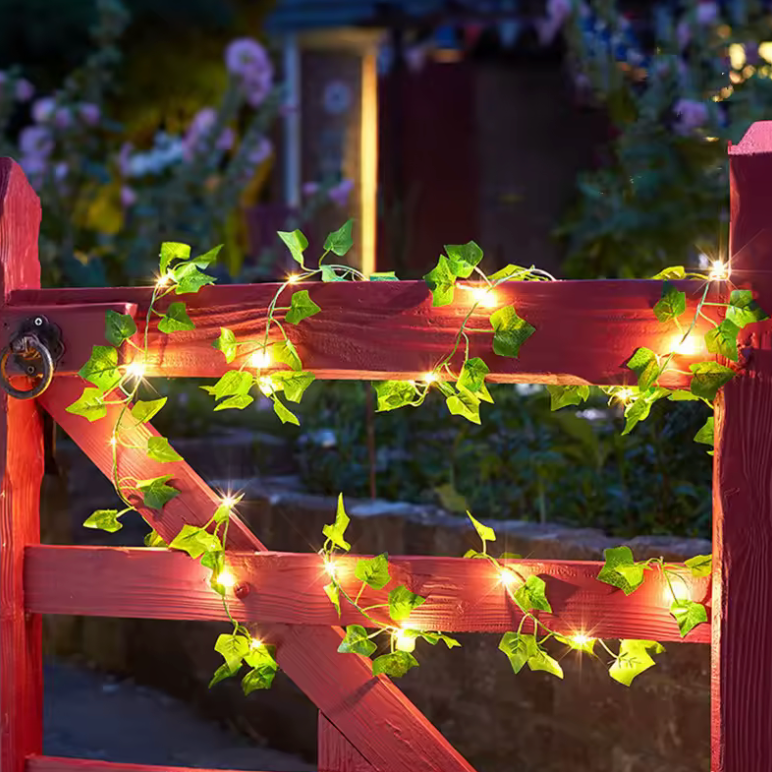 Warm LED green leaf vine fairy lights, battery operated for enchanting Christmas, wedding, or home decor.