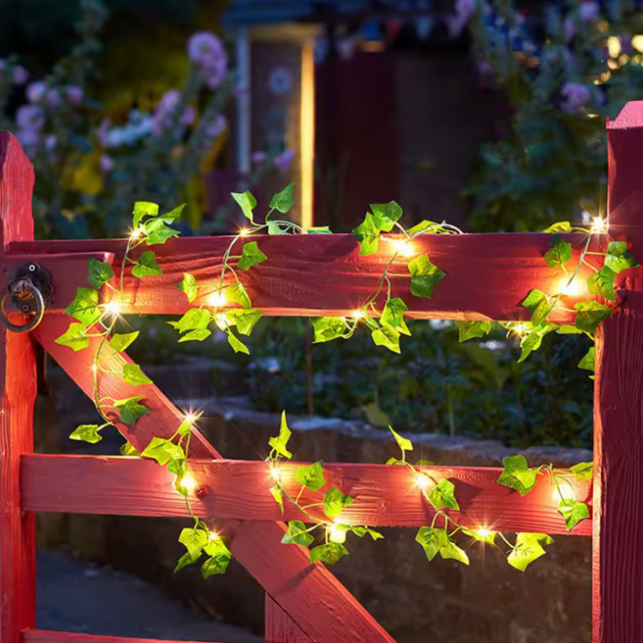 Warm LED green leaf vine fairy lights, battery operated for enchanting Christmas, wedding, or home decor.