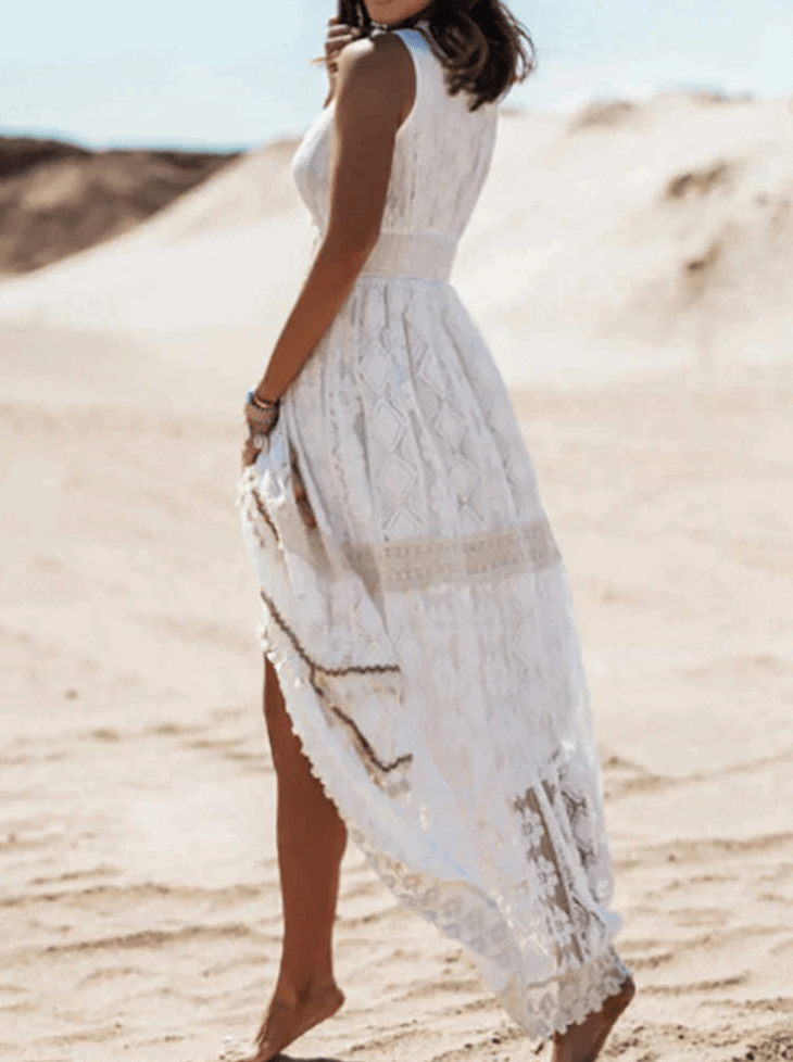 Elegant white boho crochet maxi dress for women, featuring a V-neck and stylish fringe, perfect for summer events.