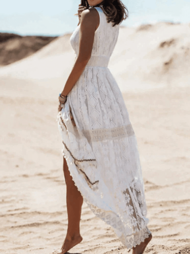Elegant white boho crochet maxi dress for women, featuring a V-neck and stylish fringe, perfect for summer events.