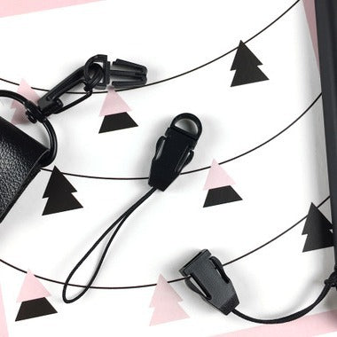 Black adjustable cord lock clips for secure fastening on apparel, gear, and bags.