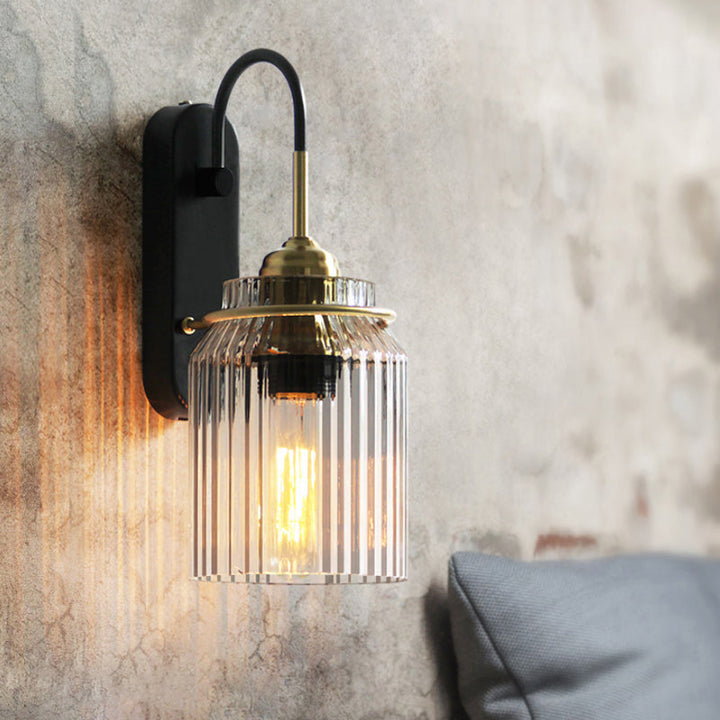 Elegant black farmhouse wall light with prismatic glass, enhancing rustic or modern home decor.