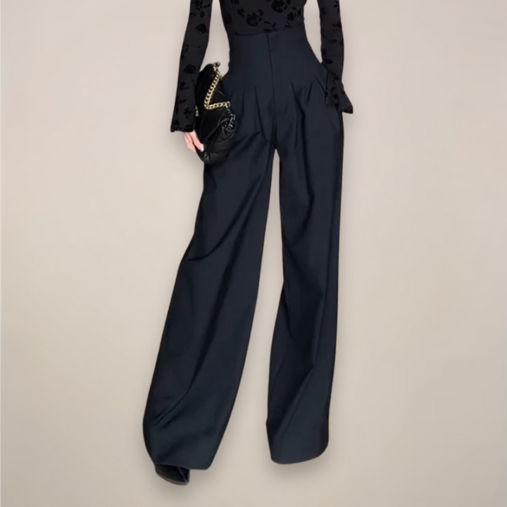 Flowy black wide-leg trousers for women, high-waisted design. Versatile pants suitable for elegant summer outfits.