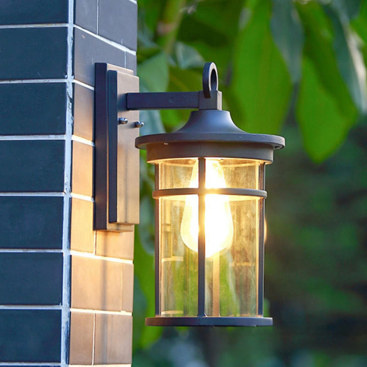 Weatherproof black industrial outdoor wall sconce, perfect for illuminating gardens and entryways.