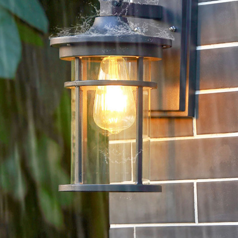 Stylish exterior industrial wall sconce, black aluminum lamp provides modern outdoor lighting.