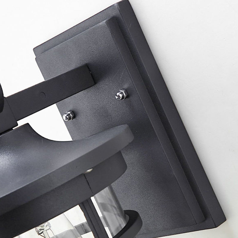 Outdoor industrial wall sconce, black aluminum and glass design ideal for patio & exterior lighting.