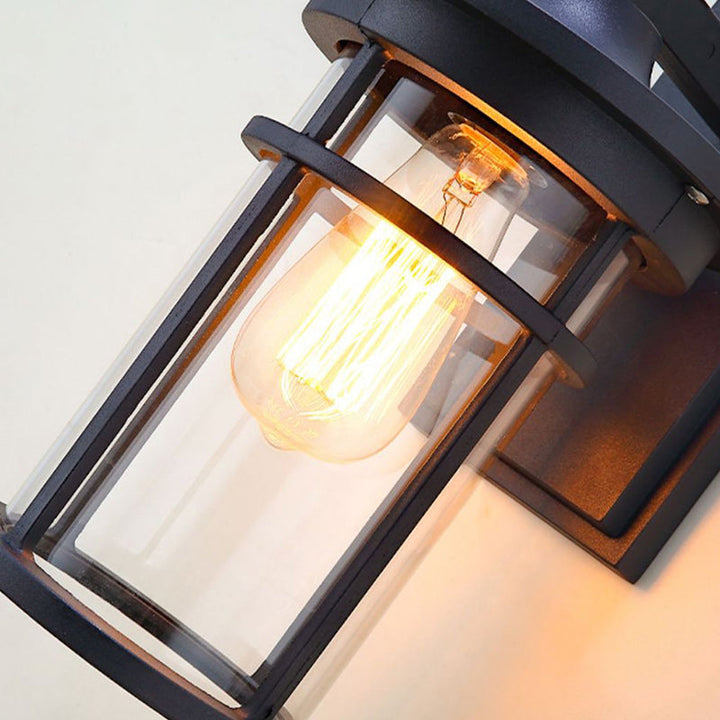 Industrial style exterior wall light, black aluminum sconce with clear glass, E26 base for patios.