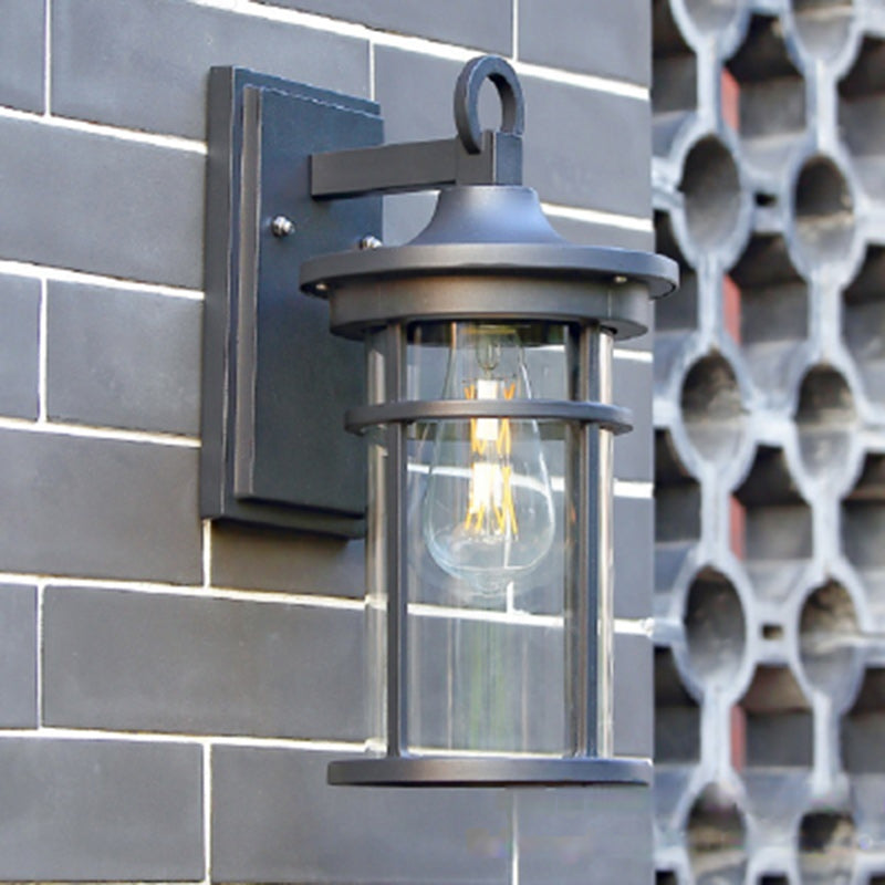 Industrial black wall light for outdoor use, durable aluminum and glass exterior patio sconce.