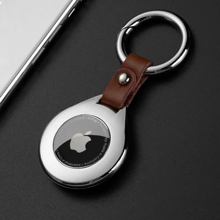 Unisex silver metal & black leather case for item tracker, stylish key finder accessory.