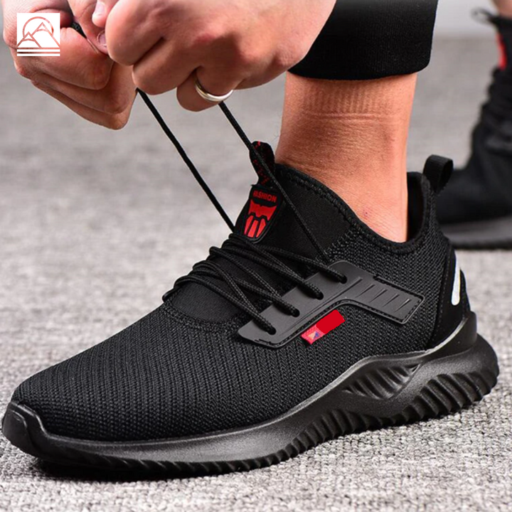 Pair of black men's lightweight safety shoes, protective toe sneakers designed for durable industrial work.