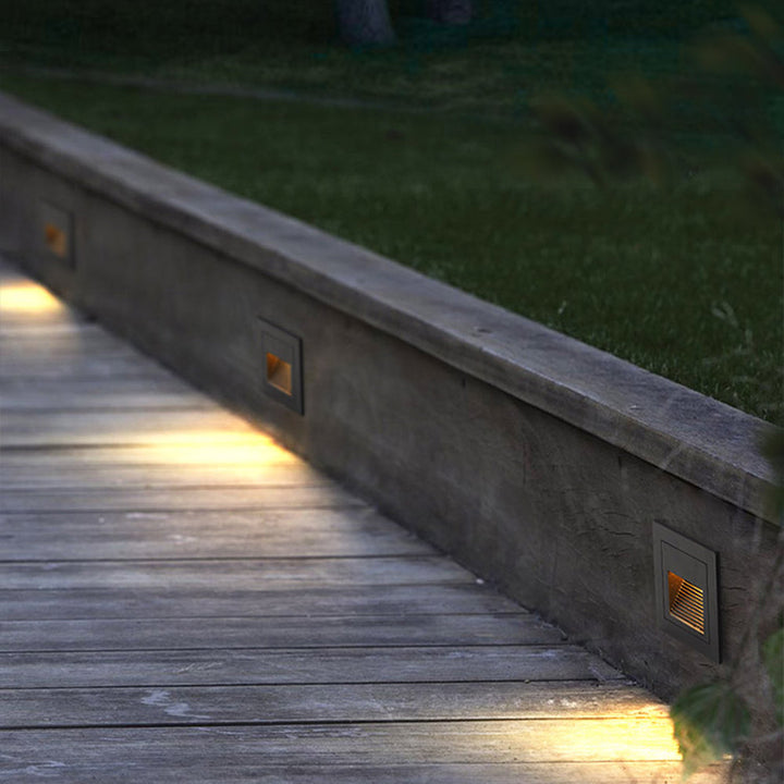 Square LED garden light for enhanced nighttime pathway safety.