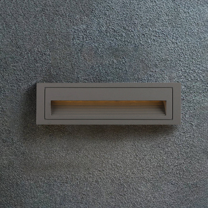 Hardwired square LED step light with motion sensor for modern gardens.