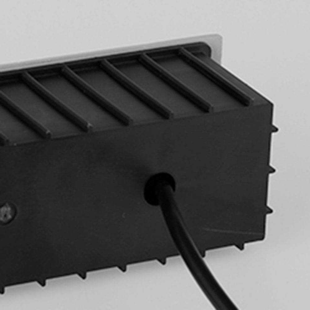 Sleek black LED step light for discreet and effective outdoor lighting.