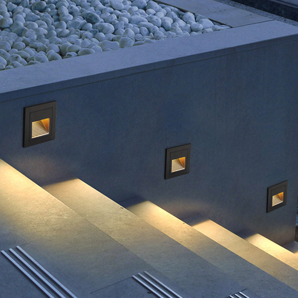 Grey outdoor LED step light with motion sensor for subtle pathway lighting.