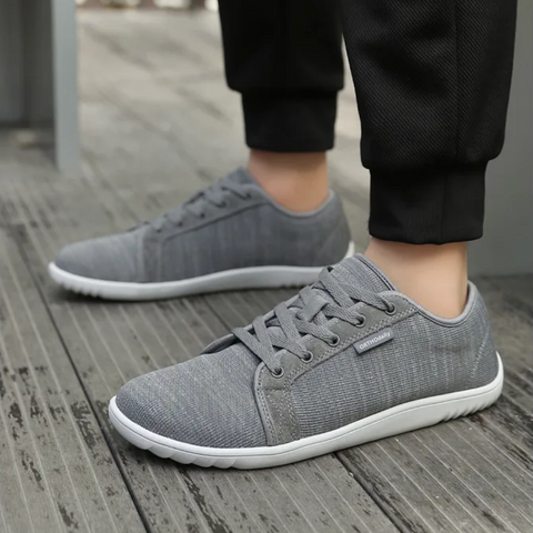 Close-up of slip-resistant, cushioned sole on a black zero-drop comfort shoe for natural walking & stability.