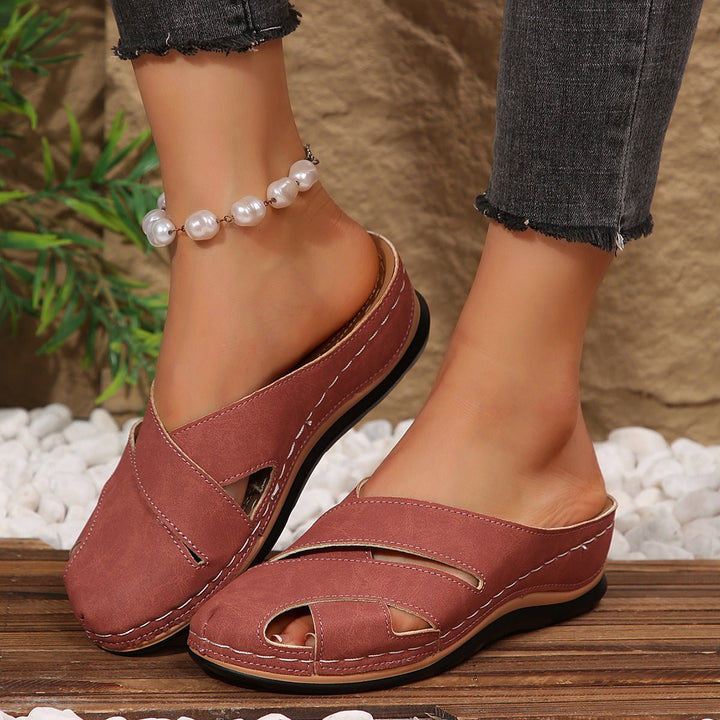 Women's blue cross-strap mule sandals, breathable and flat. Perfect slip-on comfort for summer.