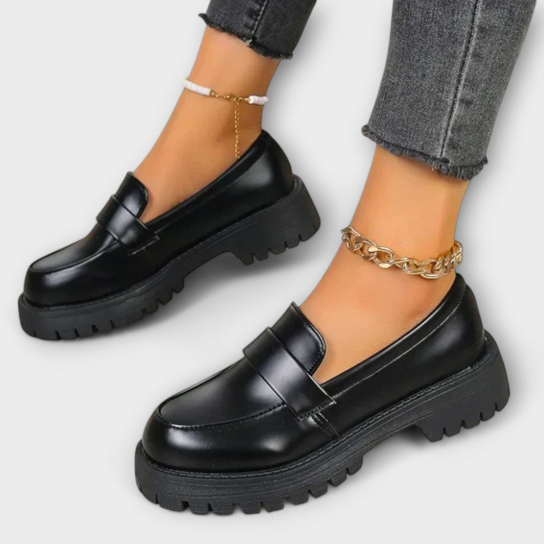 Black women's orthopaedic loafers, providing comfortable foot support and chic style for everyday wear.