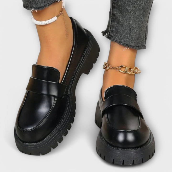 Elegant women's black slip-on loafers with orthopaedic design for comfortable walking and daily support.