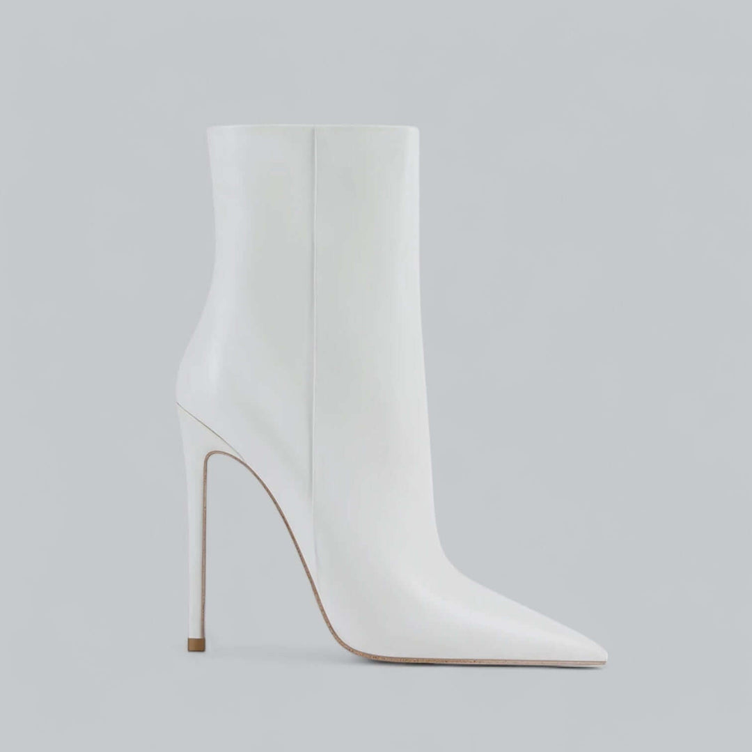 Modern women's black pointed toe stiletto ankle boots, sleek high heel chic style.