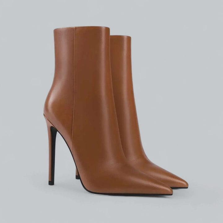 Pair of black women's pointed toe stiletto ankle boots, perfect for a chic look.