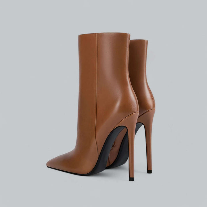 Close-up of women's elegant pointed toe stiletto ankle boot, high fashion footwear.