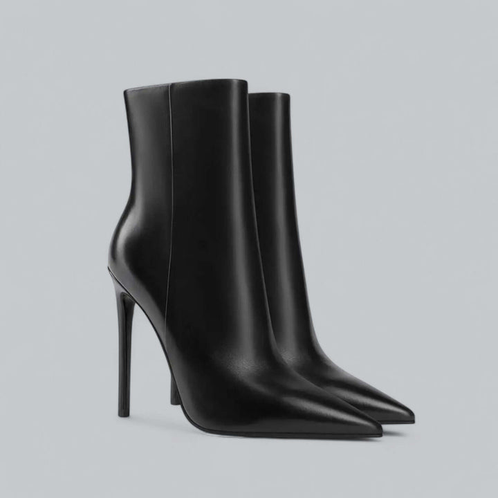 Women's pointed toe stiletto ankle boots on model, chic high heel fashion.