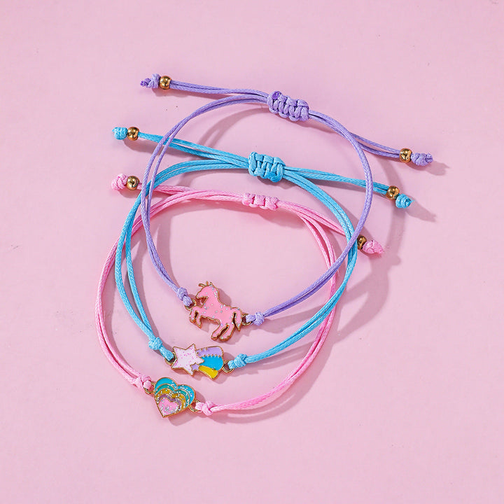 Girls' blue charm bracelet set with unicorn, rainbow, & heart charms. An adjustable friendship accessory.