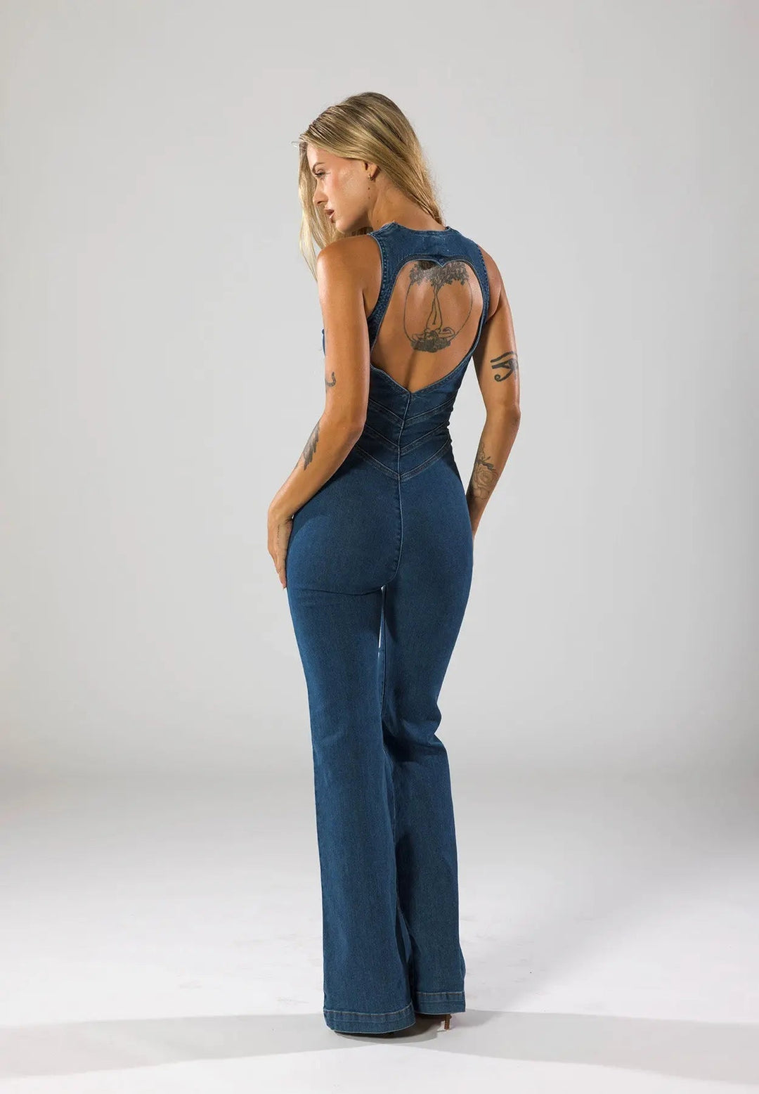 Bold blue women's fitted flared jumpsuit with a striking plunge neck. A fashion statement for evening events.