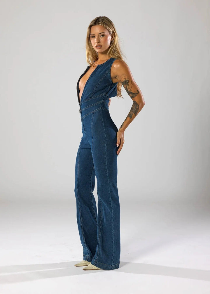 Women's blue fitted flared jumpsuit with a daring plunge neck. Sleeveless design, great for evening parties.