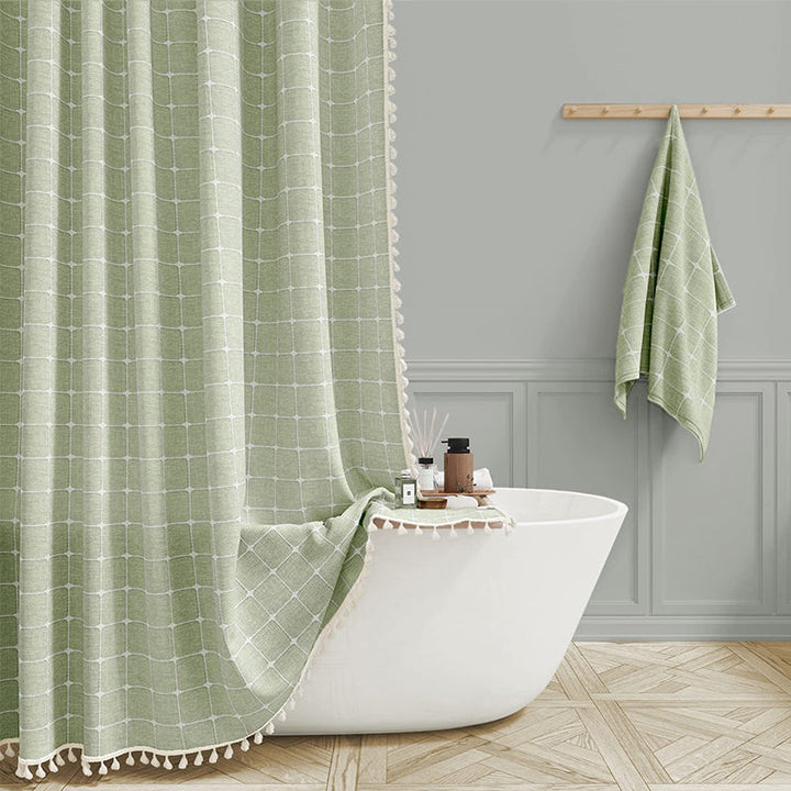 Waterproof linen shower curtain in a bohemian farmhouse design, featuring plaid pattern & tassels.
