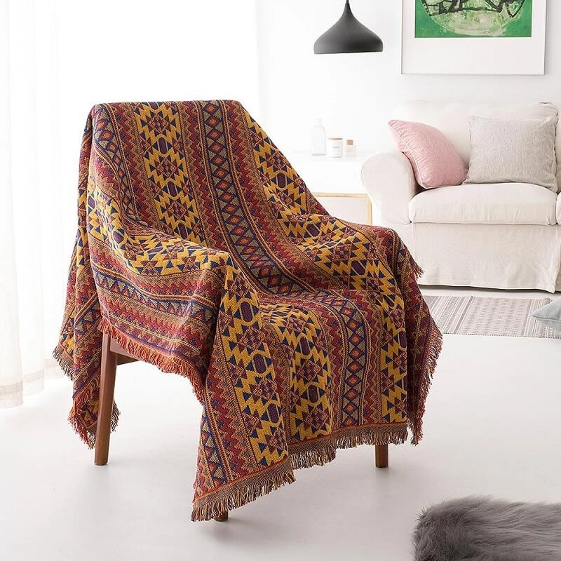 Knitted bohemian blanket with tassels, a cozy sofa throw for any living room.