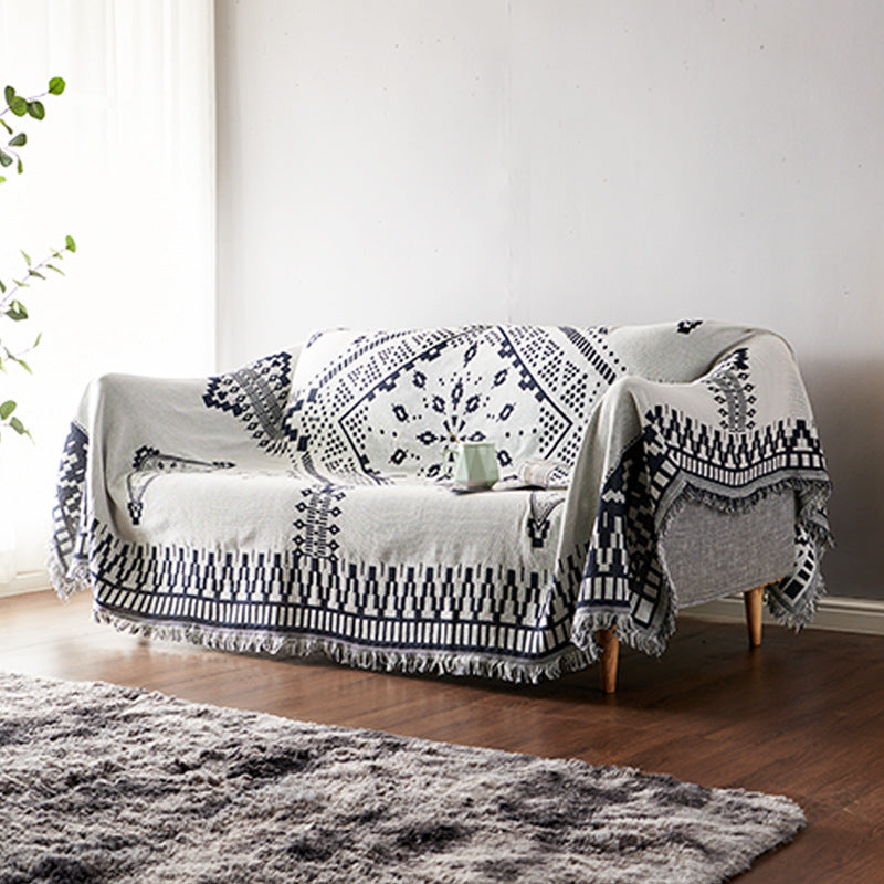 Decorative knitted bohemian blanket with tassels. A perfect sofa throw for living rooms.