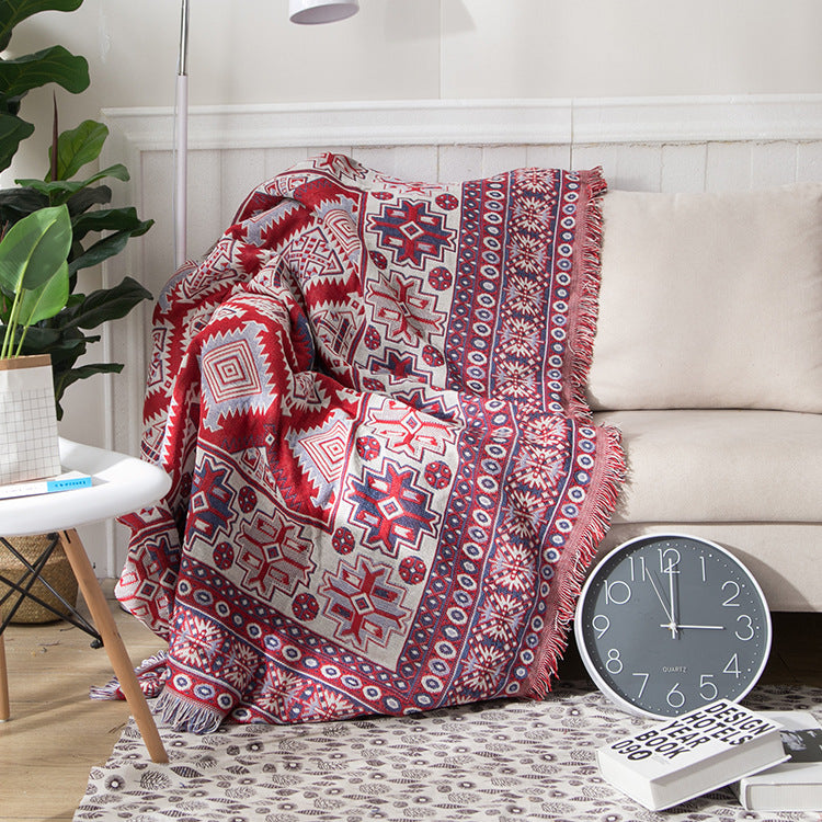 Reversible bohemian tassel throw. Knitted blanket for sofa, adding cozy home accent.