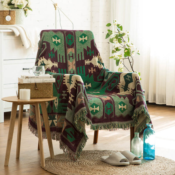 Cozy knitted bohemian throw for sofas, featuring tassels and ethnic patterns.
