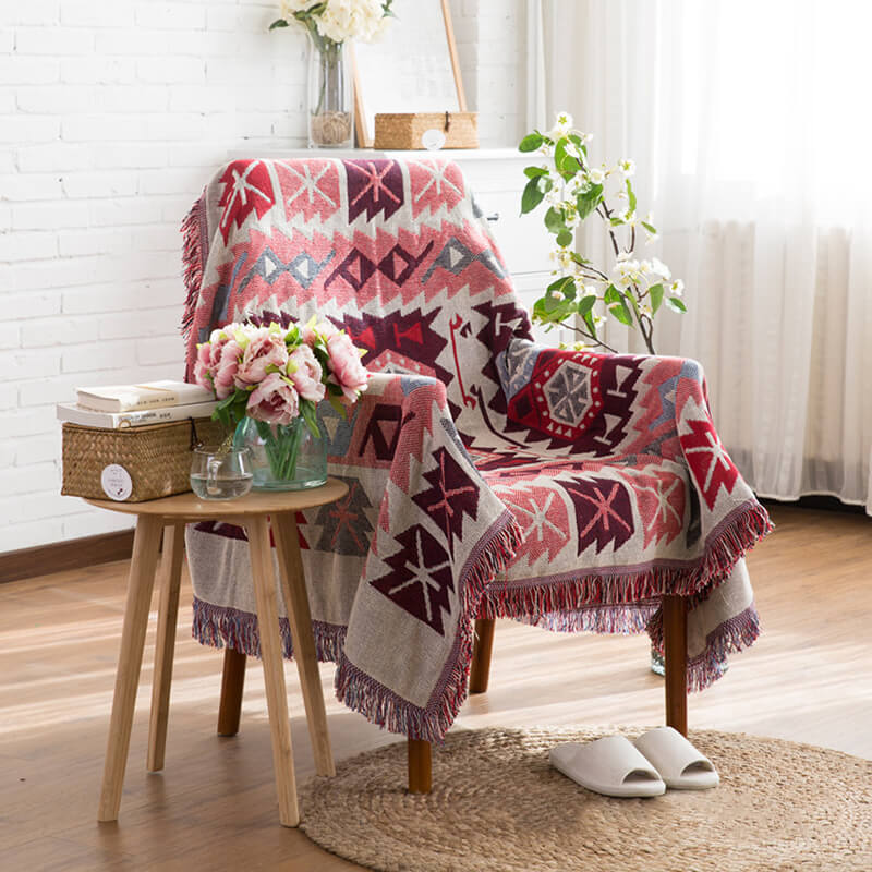 Living room bohemian knitted throw blanket with tassels. Perfect decorative sofa cover.