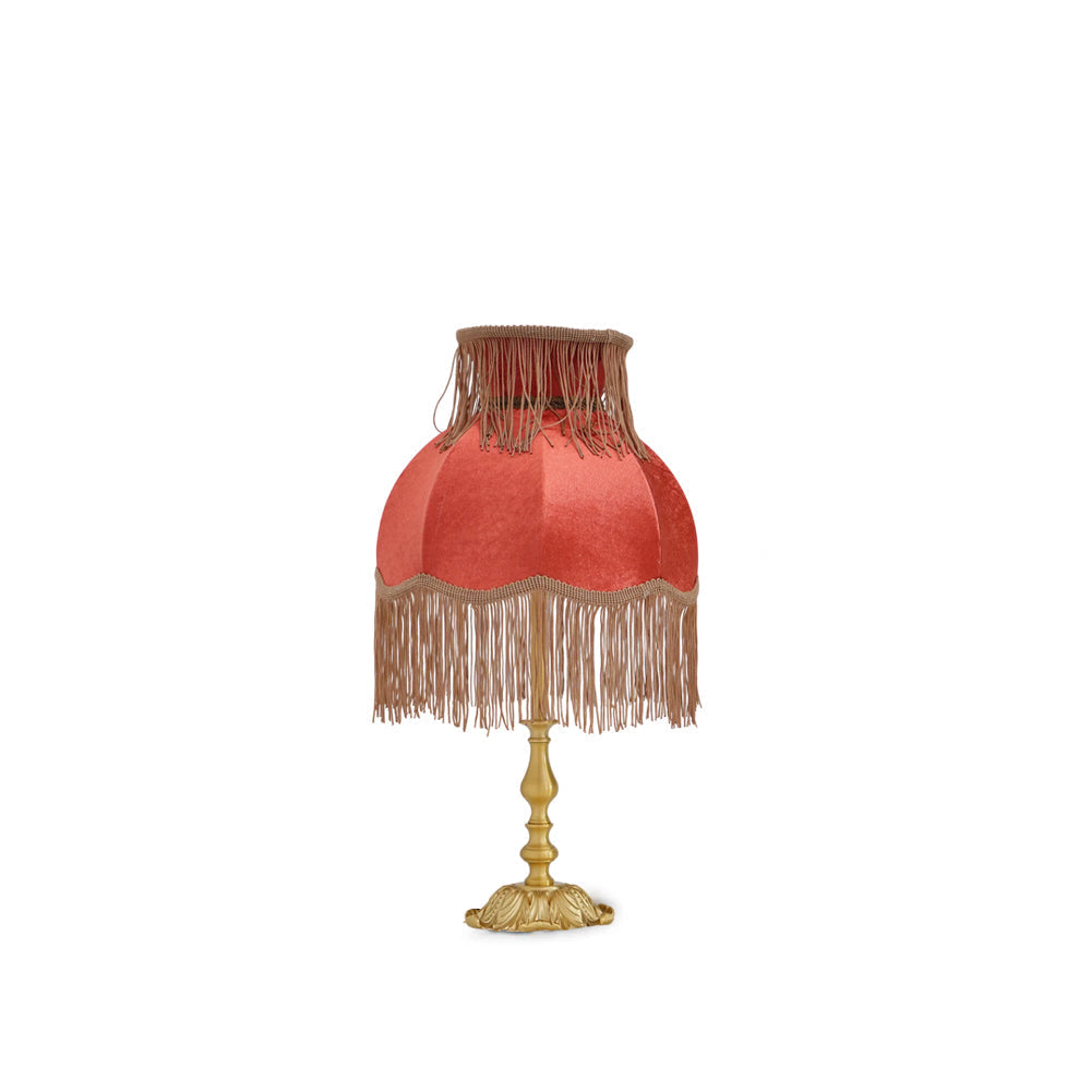 Bohemian red tassel table lamp, warm glow for living room decor. Modern eclectic accent lighting.