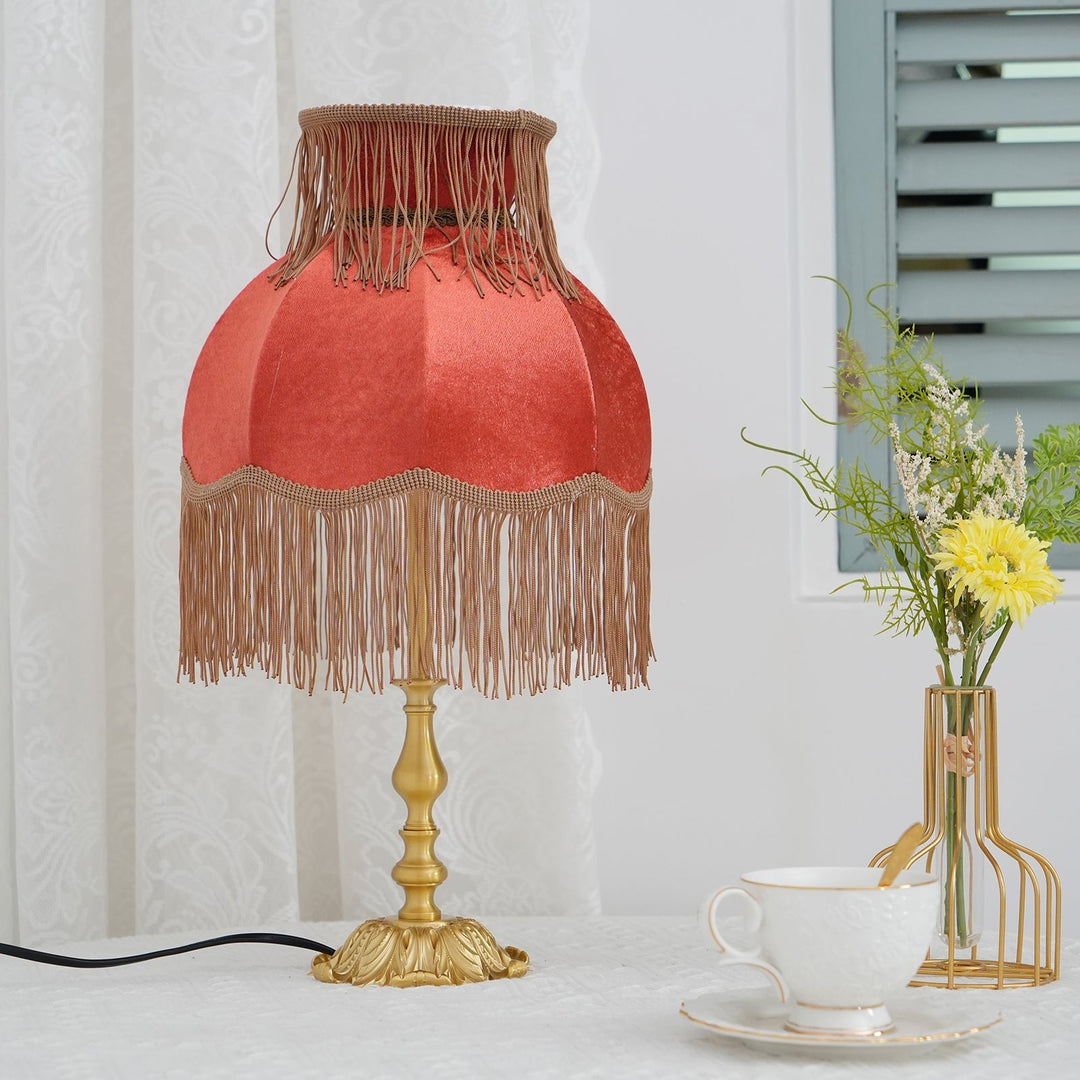 Decorative lighting: red bohemian tassel table lamp, ideal for accenting modern eclectic spaces.