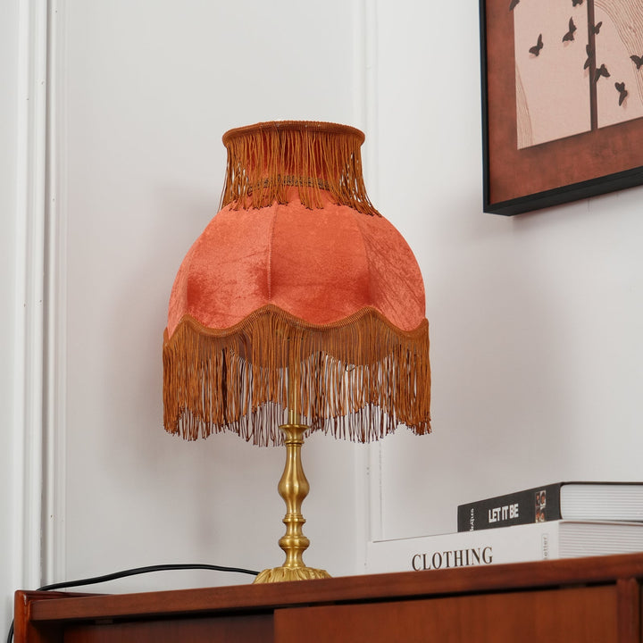Accent lamp: red bohemian table lamp featuring charming tassel details and a warm ambiance.